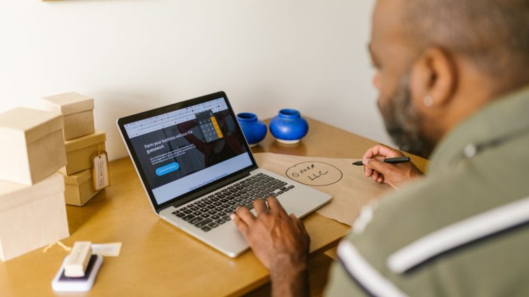 Business owner working on a laptop, wondering if he needs a website for his business