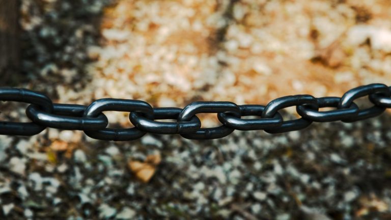 Black metal chain links stretched across a blurred background, a nod to building links for your business