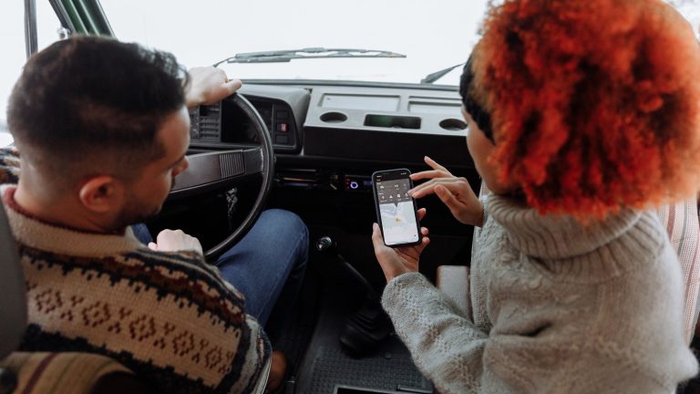 Couple checking a map on a phone, the kind of near me searches local businesses want to show up in