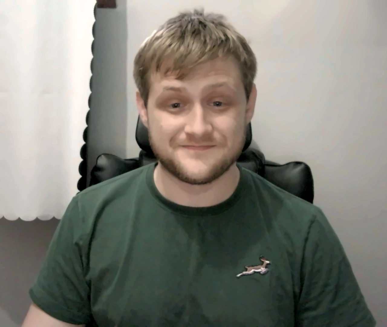 Joshua, founder of Net Narrator, smiling in a green T-shirt
