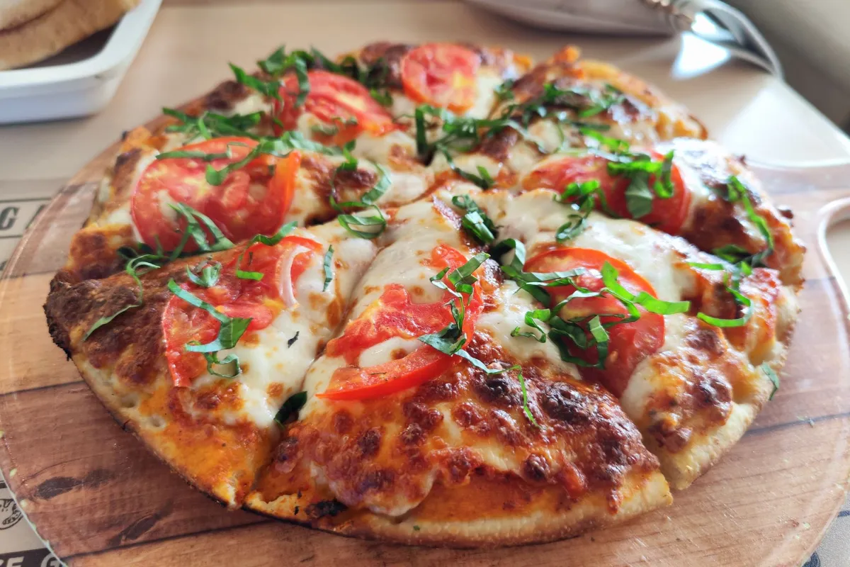Fresh Margherita pizza with tomato and basil, the kind of local search people make every day