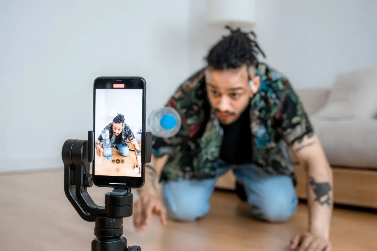 Man filming short-form video content on a smartphone mounted on a gimbal